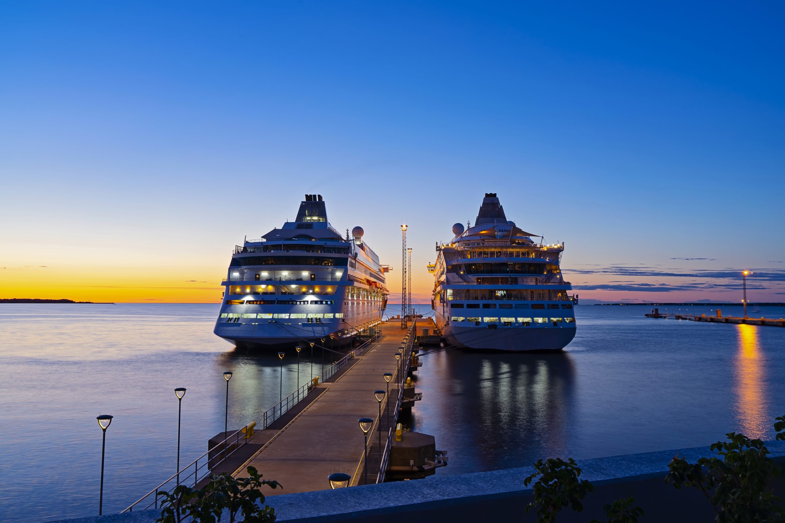 Two large passenger liner in port during sunset
